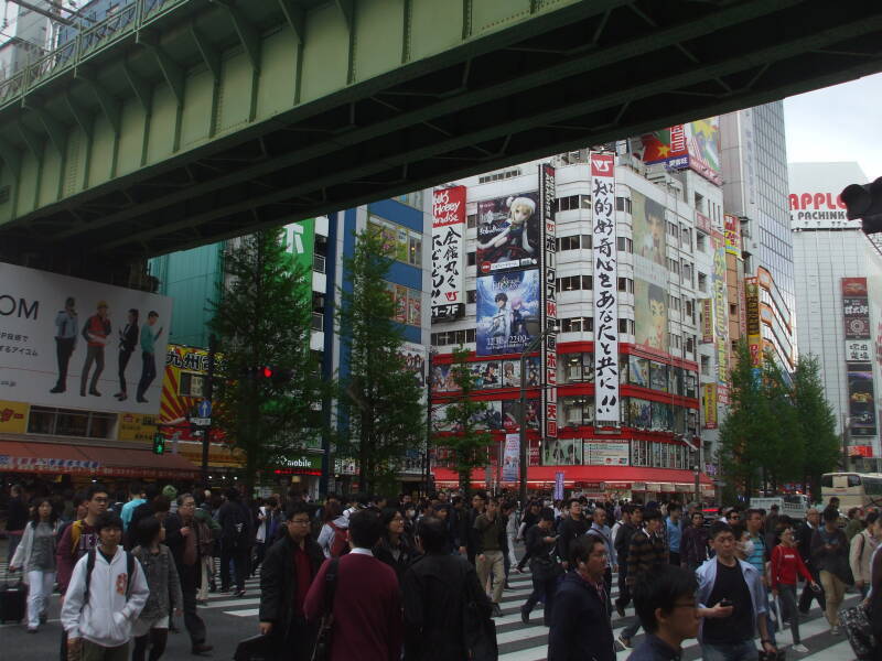 Train line crosses over a busy street in Akihabara.