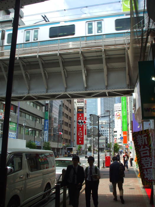 Train passes above the street in Akihabara.