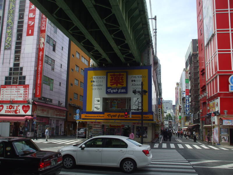 Train line crosses over a busy street in Akihabara.