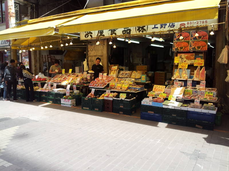 Seafood and fruits and vegetables for sale in the Ameya-Yokochō market under the Yamanote Line tracks.