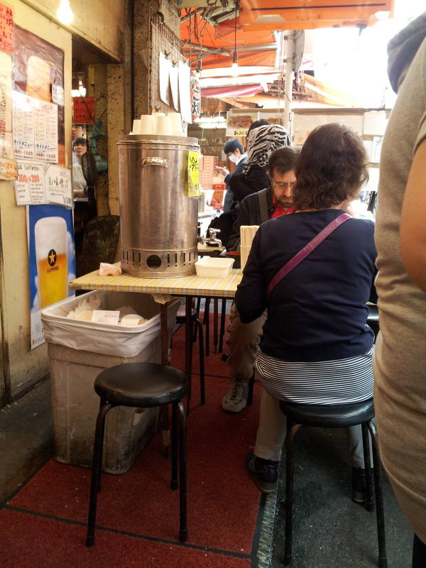 My seat at a small restaurant in the Ameya-Yokochō market under the Yamanote Line tracks.