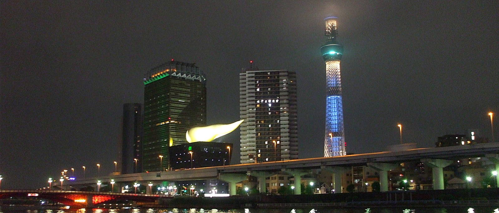 Lighted buildings at night along the Sumida River in Asakusa, Tōkyō