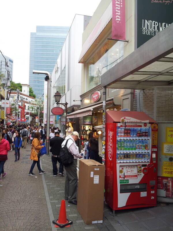 Vending machine and shops on Takeshita-dori or Takeshita Street in Harajuku.
