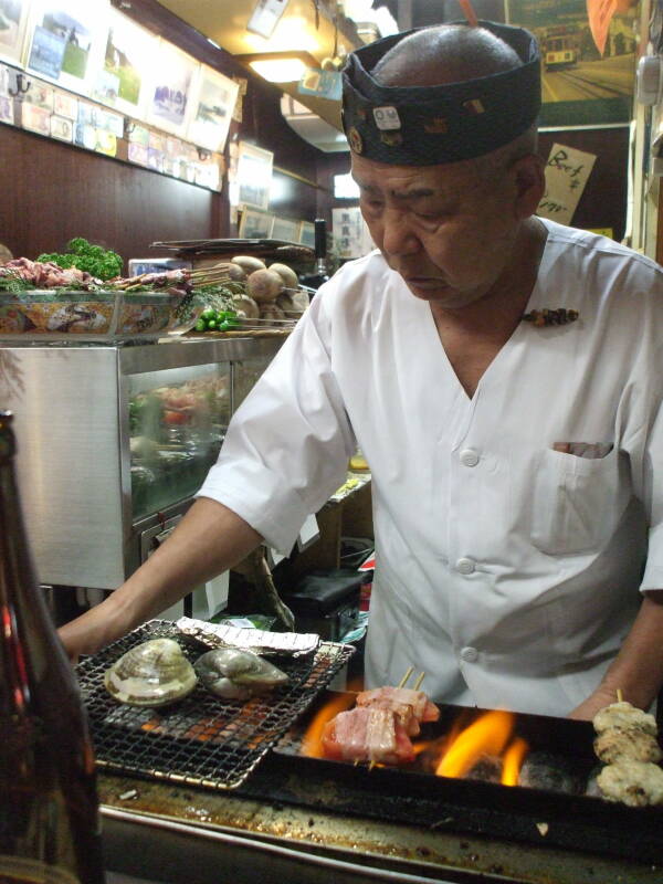 Variety of seafood on the grill at a small izakaya in Omoide Yokochō, Shinjuku, Tōkyō