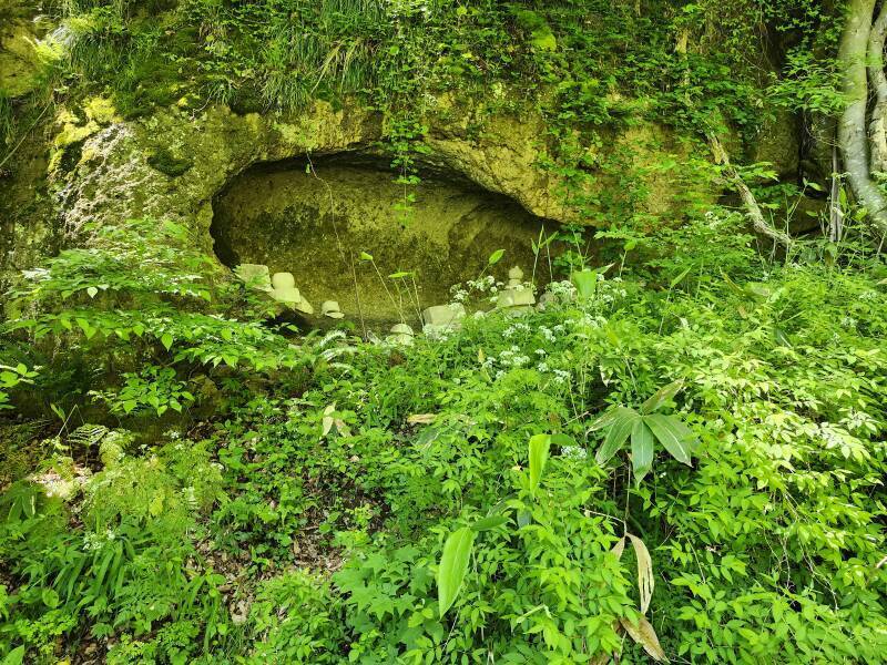 Cave with multiple gorintō or five-ringed tower grave markers.