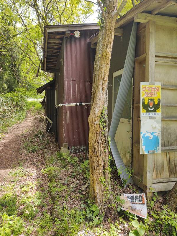 Trail maintenance shed and a bear warning sign.