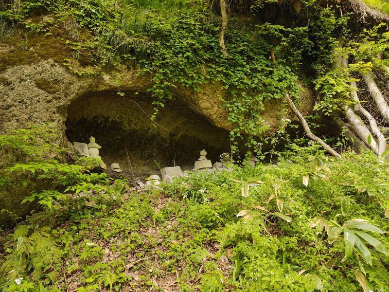 Cave with multiple gorintō or five-ringed tower grave markers.