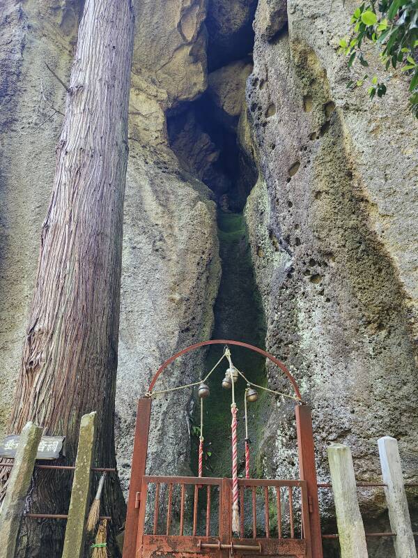 Small Shintō shrine, and behind it, statue of Buddhist deity Fudō Myōō, the Immovable Wisdom King, at Tarumizu.