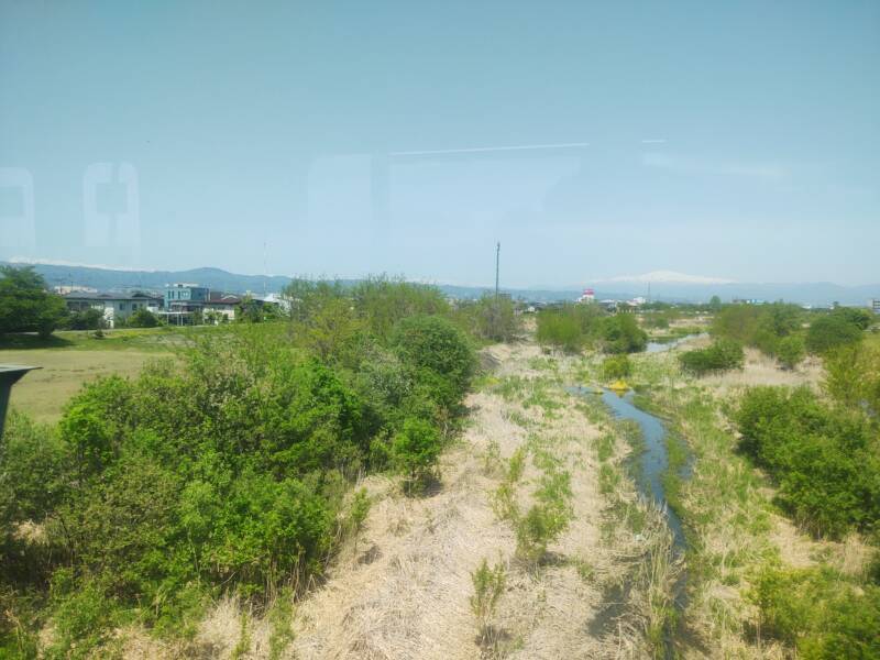 View of mountains to the northwest from a train en route from Yamagata to the Yamadera temple complex.