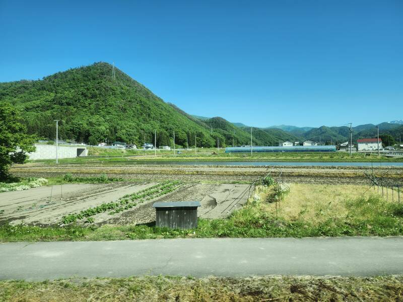 View of rice paddies and mountains to the south of the line as we enter the mountains on a train en route from Yamagata to the Yamadera temple complex.