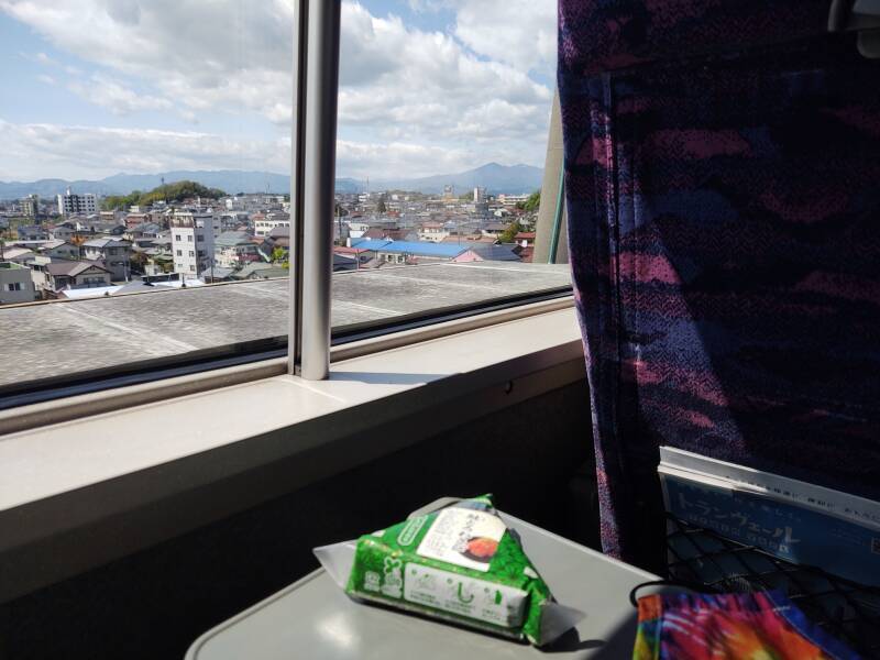 Seated on board a north-bound Shinkansen headed for Yamagata, looking out over Koriyama rooftops.