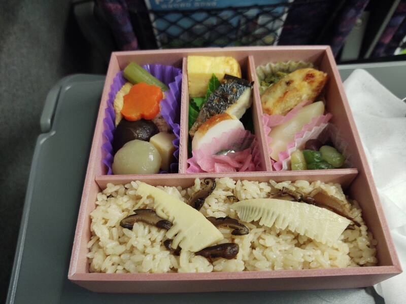 Opening a bentō lunch on board the Shinkansen.