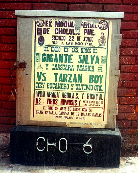 Lucha libre poster, or masked Mexican wrestling poster, in Cholula, Mexico.  Many lucha libre or Mexican wrestling stars are listed: Gigante Silva, Mascara Magica, Tarzan Boy, and Virus Hipnosis.