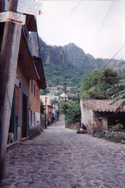 Mountains above a cobblestone street in the Mexican town of Tepoztlán.