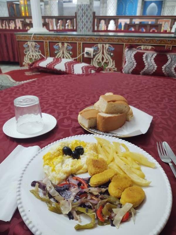 Dinner at the Hotel Moroccan House in Casablanca: cheese omelette, fried peppers and cabbage, fried chicken, and french-fried potatoes.