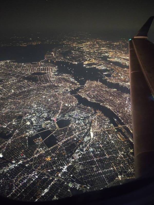 New York City from the air at night, looking southwest from over Queens.