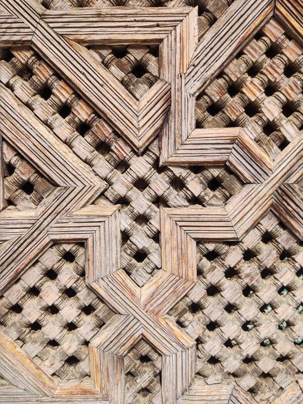 Decorative cedar screens obscure galleries around the courtyard of the Bou Inania Madrasa in Fez.