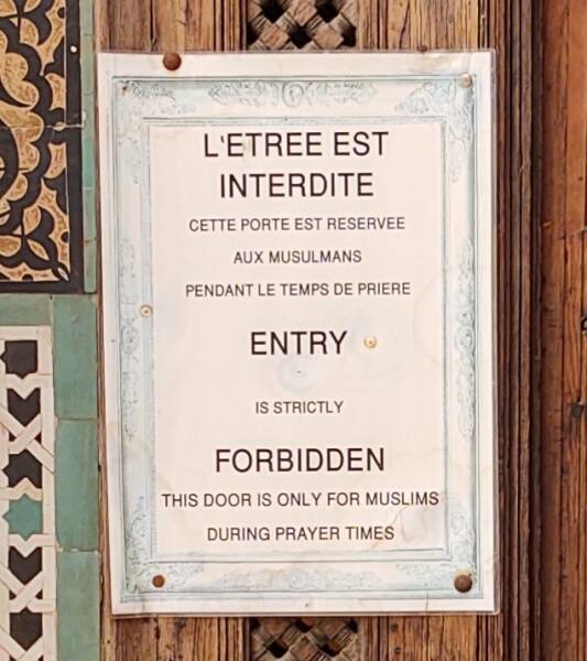 Sign on the door to the prayer hall in the Bou Inania Madrasa in Fez.