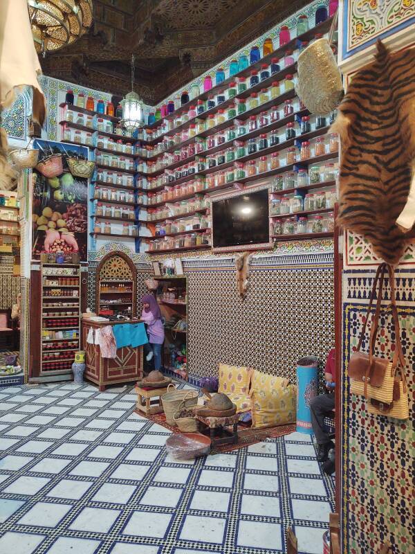 Array of spices, perfumes, and pharmaceuticals in the entryway of a spice shop in Fez el Bali medina along Tala'a Sghira.