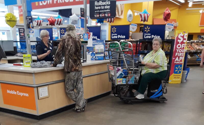 Man in a U.S. Walmart wearing three different camouflage patterns.