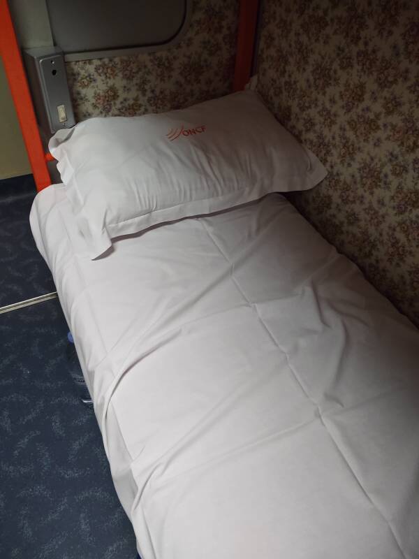 Making up my bed, putting the linen on the couchette berth on board the overnight train between Marrakech and Tangier.