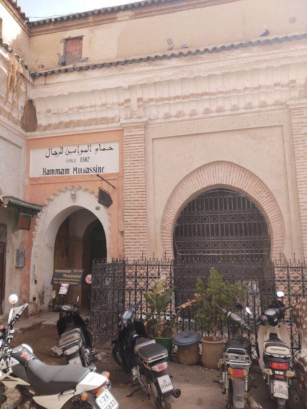 Arched door into Hammam Mouassine and associated fountains in the medina in Marrakech.