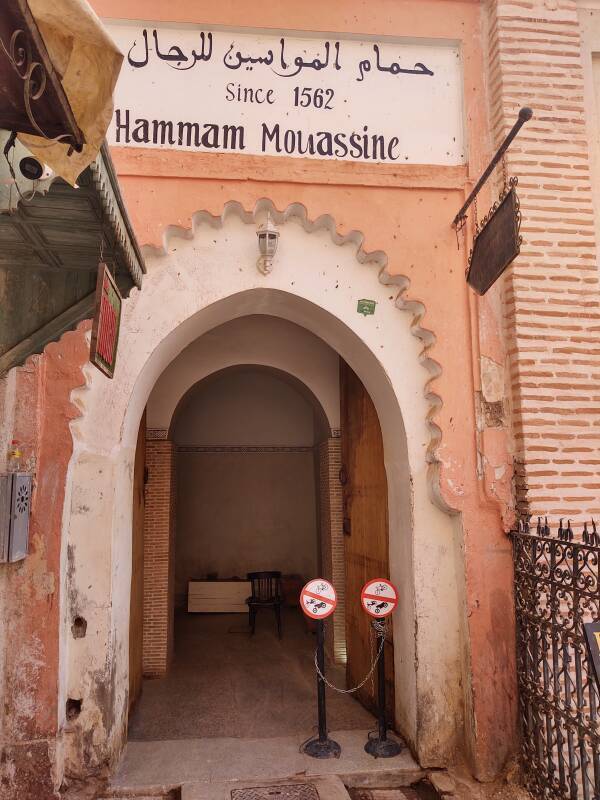 Arched door into Hammam Mouassine with a sign saying 'Since 1562'.