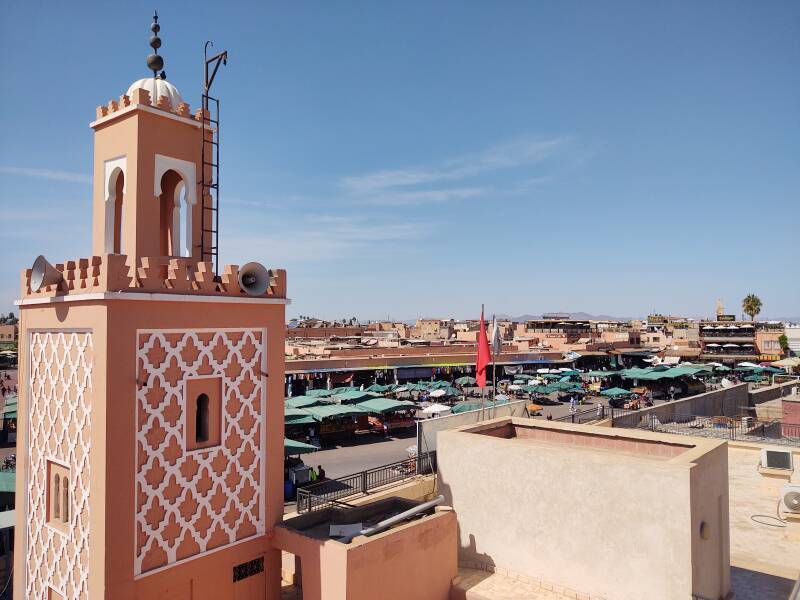 ALT: View from a rooftop café overlooking Sāḥat Jāmi' al-Fanā', or The Mosque at the End of the World, in central Marrakech.