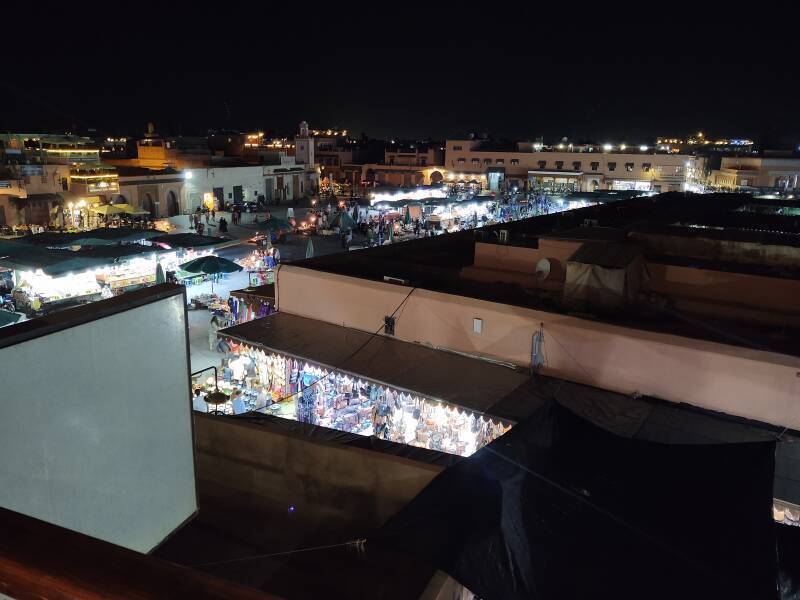 Night-time view across Sāḥat Jāmi' al-Fanā', or The Mosque at the End of the World, from a rooftop cafe on its north side.