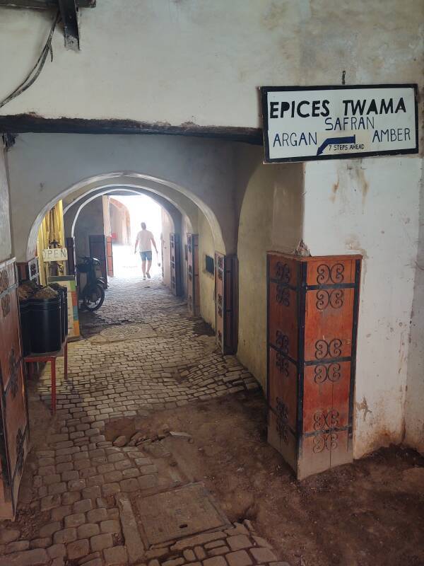 Entry to a funduq in the medina, sign 'Epices Twama' with argan, safran, and amber.