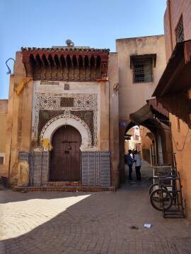 Two men talk in a narrow passageway of the medina in Meknès.
