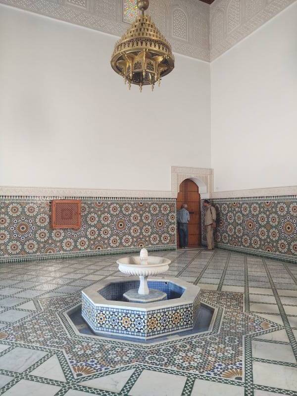 Two men in the entry chamber of the Mausoleum of Moulay Ismail.