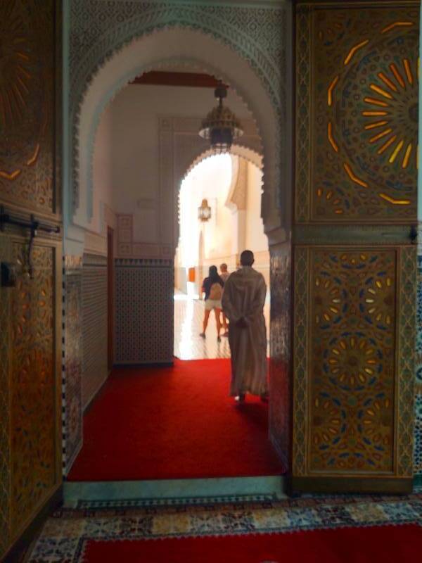 Attendant watches visitors leave the Mausoleum of Moulay Ismail.