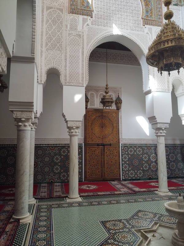 Fountain, lamp, and elaborate door in the Mausoleum of Moulay Ismail.