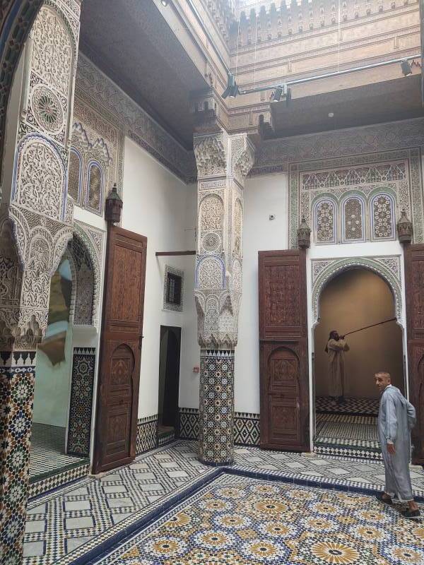 A man walks through a beautifully decorated room in the Dar Jama'i museum in Meknès.