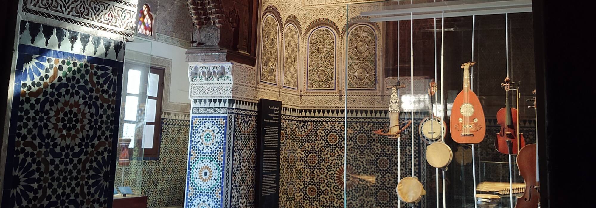 Zellij tilework, carved stucco, and stained glass in the Dar Jama'i Museum in Meknès.