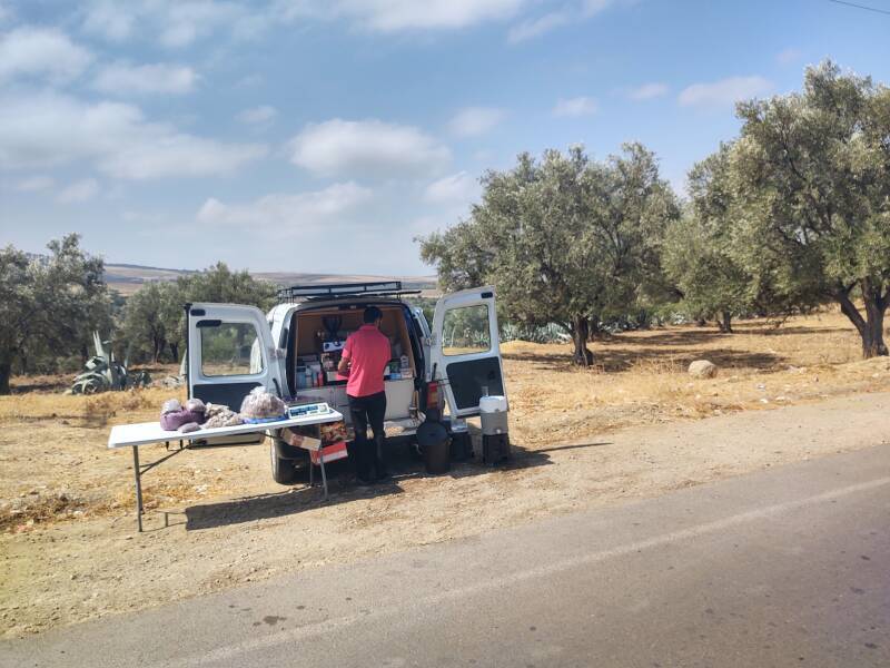 Man selling tea and coffee out of his car on the road to Volubilis archaeological site in Morocco.