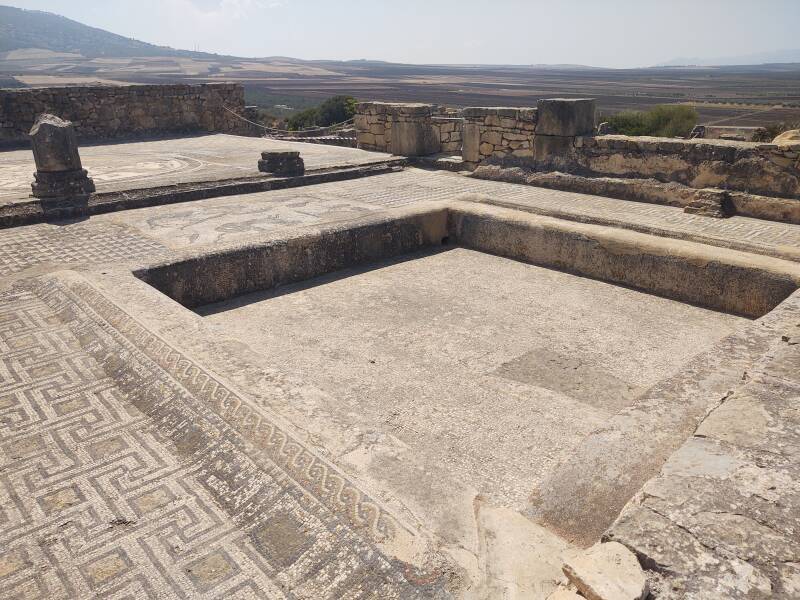 Mosaic and pool with triclinum at Volubilis archaeological site in Morocco.
