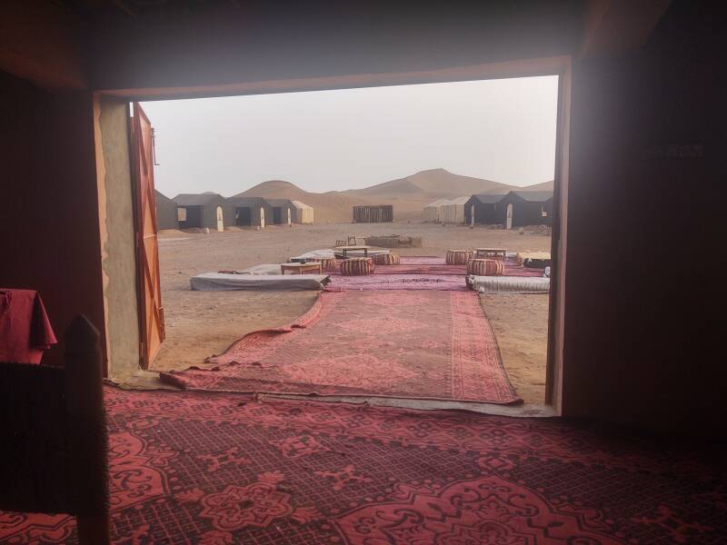 View out of the dining area to the tents of the camp. Beyond that, a 150-meter dune.