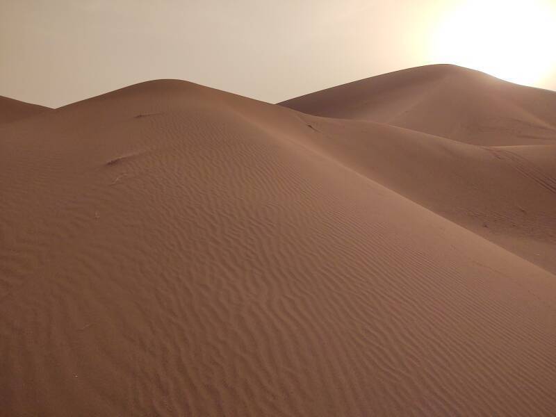 Sun above a 150-meter dune at Erg Chigaga.