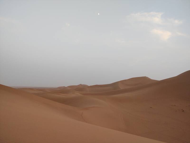 62% full moon above 150-meter dunes at Erg Chigaga.