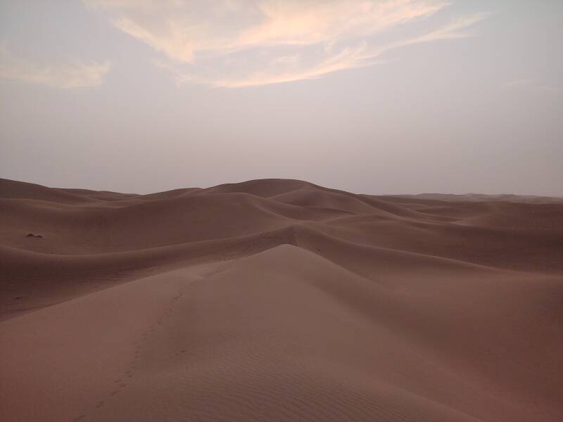 Clouds and dust haze above dunes just after sunset at Erg Chigaga.