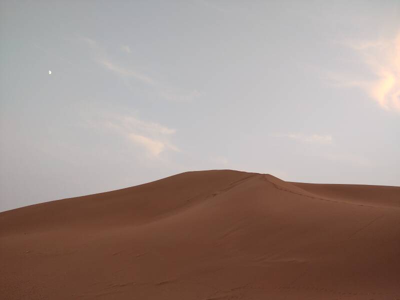 62% full moon above dunes at Erg Chigaga.