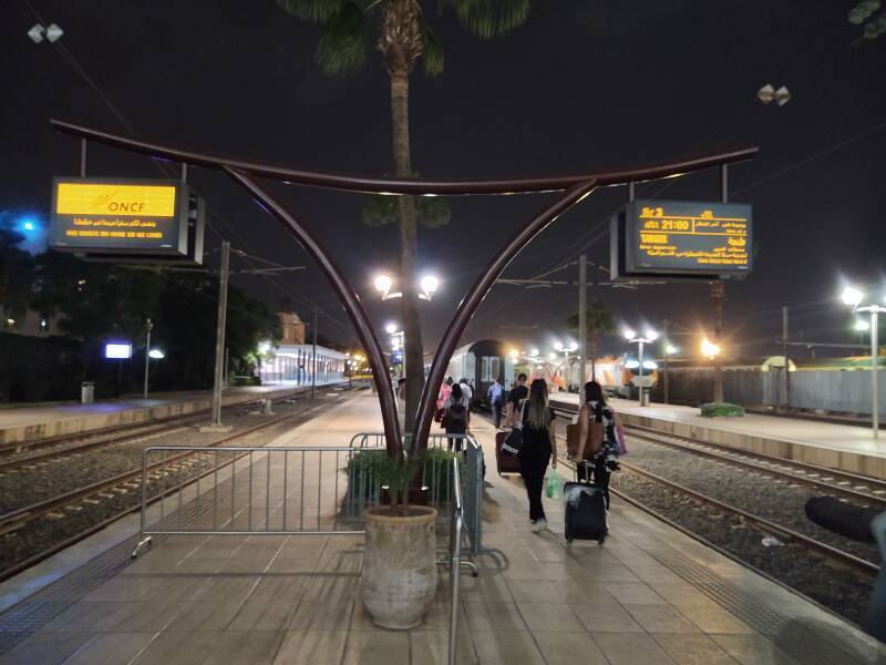 Passengers walk out the platform at the Marrakech train station to board the sleeper train to Tangier.