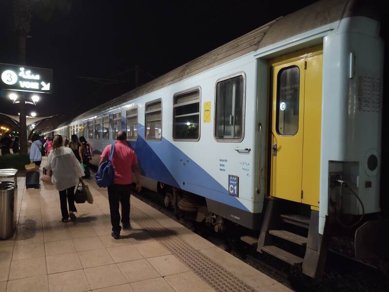 Passengers walk out the platform at the Marrakech train station to board the sleeper train to Tangier.