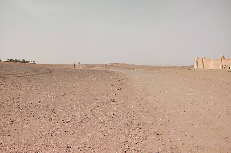 Looking past M'Hamid's school into the desert, tracks passable by four-wheel-drive vehicles and off-road motorcycles.