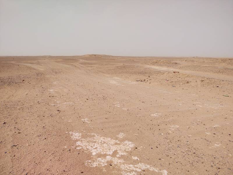 Looking past M'Hamid's school into the desert, tracks passable by four-wheel-drive vehicles and off-road motorcycles.