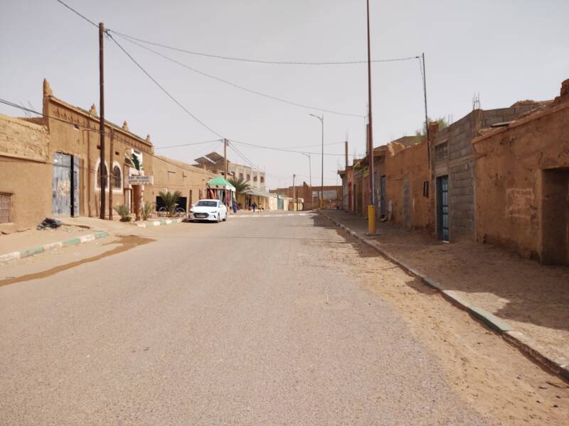 Walking east along the main street through M'Hamid.