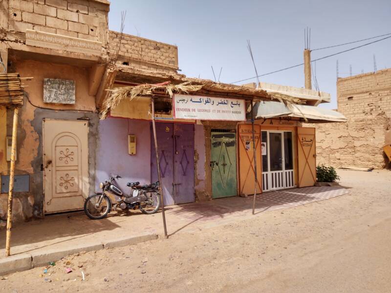 Vegetable and fruit shop and a barber shop near the center of M'Hamid.