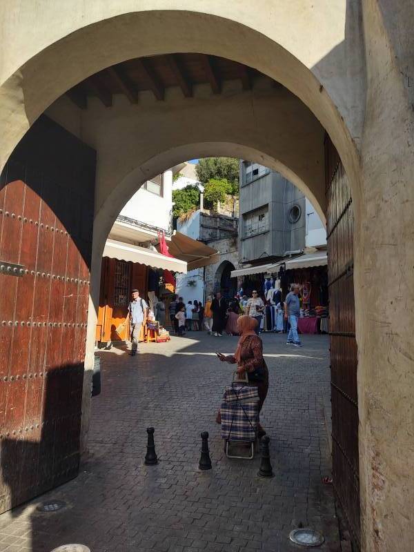 Woman crossing the gate into the medina in Tangier.